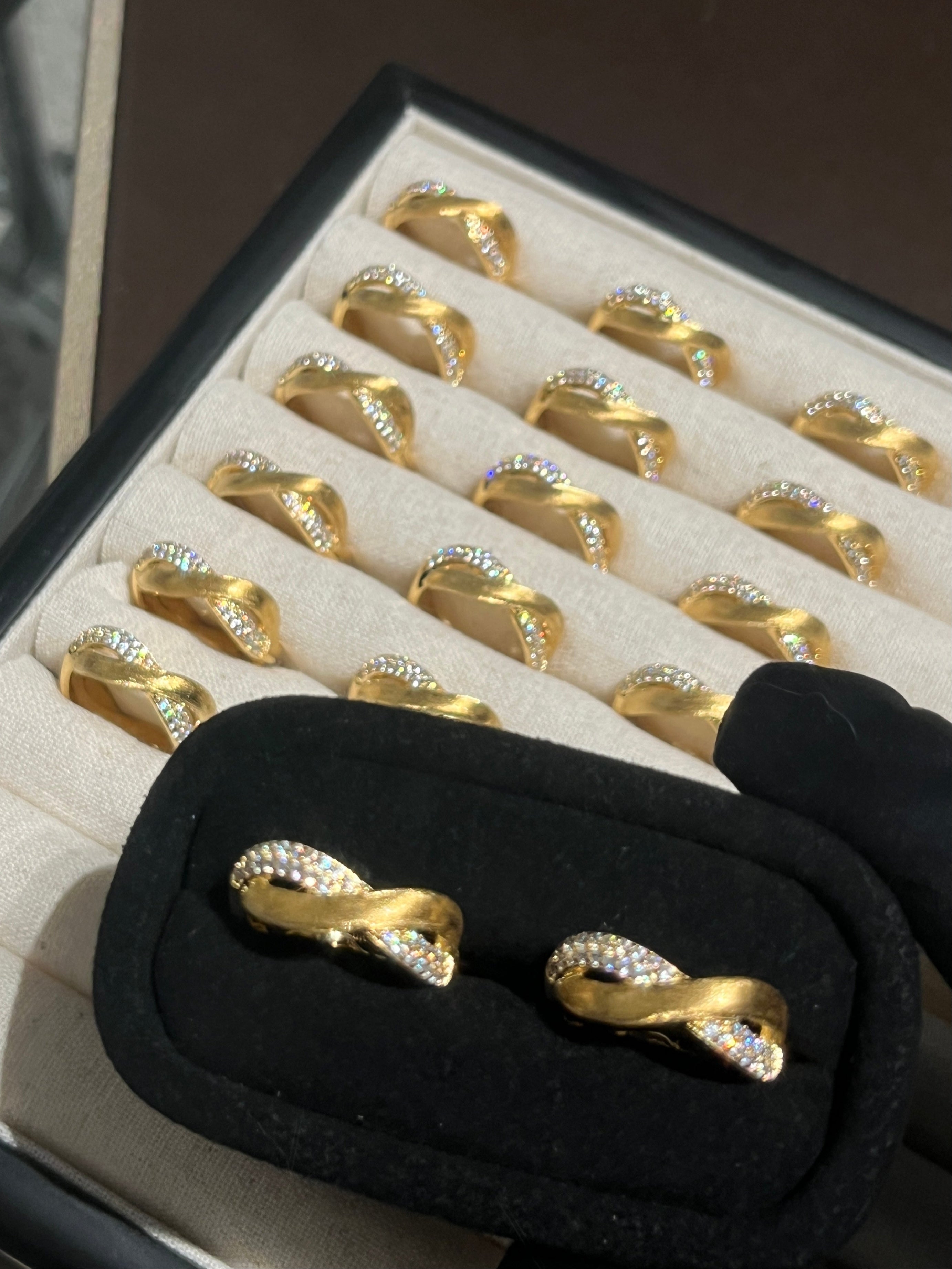 Elysian Jewelry 925 silver with 18k plated gold earrings with infinity design on a jewelry box